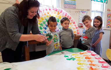 Parkside Preschool students enjoying an art class with teacher in Newton, MA