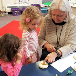 preschool teacher providing help and guidence to student