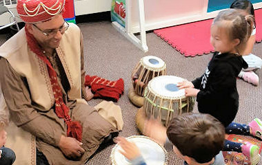 Newton preschool students learning about using drums from India