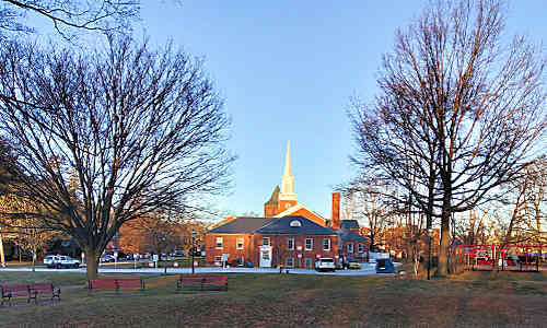 Entrance to Parkside Preschool in school wing of Eliot Church showing off-street parking and abutting park 